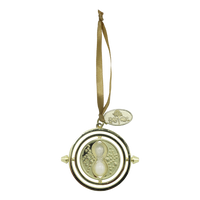 Gold time-turner ornament with a ribbon on a white background