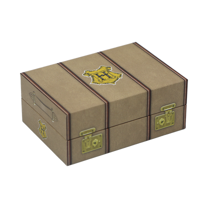 Brown trunk storage box with gold accents and a Hogwarts crest on a white background