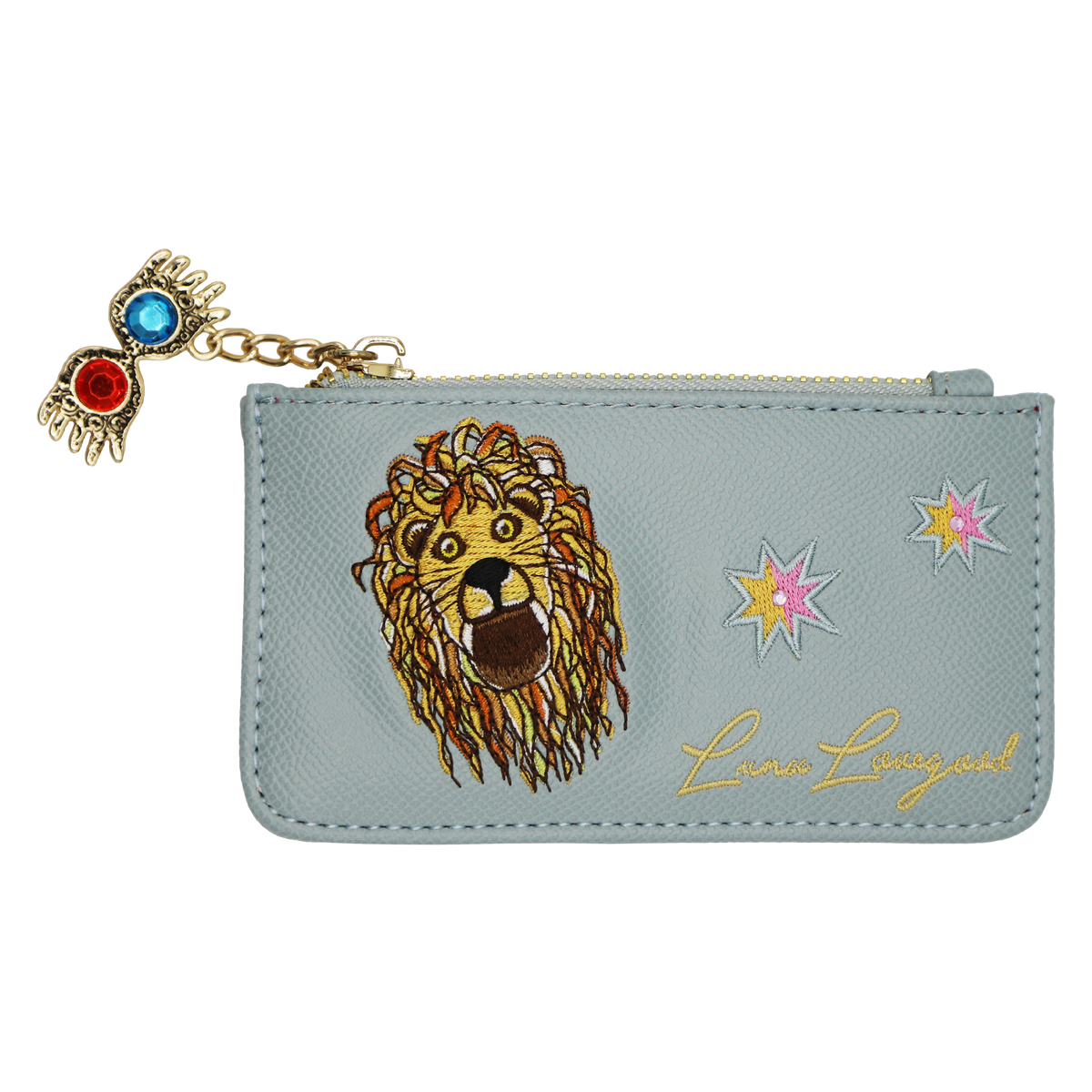 A light blue faux leather zippered pouch featuring a large embroidered lion face, two star motifs, gold cursive 'Luna Lovegood' script, and a dangling Spectrespecs charm with red and blue stones on a gold chain.