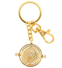 A gold-colored keychain replica of Hermione's Time-Turner from Harry Potter, featuring a clock-like device with a golden-plated hook.
